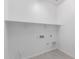 Laundry room view showcasing white walls, light tile floor, and installed shelving at 21845 E Bonanza Ct, Queen Creek, AZ 85142