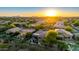 Stunning sunset aerial view of desert homes with mature landscaping, pools, and mountain views at 22847 N 53Rd E St, Phoenix, AZ 85054