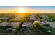 Sunset aerial view of a desert home with a beautiful pool and outdoor living space at 22847 N 53Rd E St, Phoenix, AZ 85054