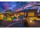 Backyard featuring a pool, desert landscaping, and patio furniture at dusk under an expansive tree at 22847 N 53Rd E St, Phoenix, AZ 85054