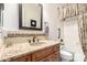 Well-lit bathroom with a dark wood vanity, granite countertop, decorative tile backsplash and shower/tub with curtain at 22847 N 53Rd E St, Phoenix, AZ 85054