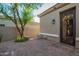 Exterior of a home showing decorative iron door, stone pavers and mature landscaping at 22847 N 53Rd E St, Phoenix, AZ 85054