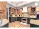 Well-appointed kitchen featuring custom cabinetry, stainless steel appliances, a tile backsplash, and elegant countertops at 22847 N 53Rd E St, Phoenix, AZ 85054