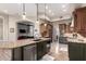Spacious kitchen with custom cabinetry, granite countertops, a large island, stainless steel appliances, and wood floors at 22847 N 53Rd E St, Phoenix, AZ 85054