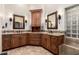 Main bathroom with dual sinks, custom cabinetry, and elegant mirrors, creating a luxurious and functional space at 22847 N 53Rd E St, Phoenix, AZ 85054