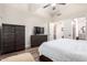 Comfortable main bedroom featuring hardwood floors, a ceiling fan, and an ensuite bathroom at 22847 N 53Rd E St, Phoenix, AZ 85054