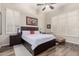 Serene main bedroom with plantation shutters, dark wood furniture, hardwood floors, and ample natural light at 22847 N 53Rd E St, Phoenix, AZ 85054