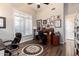 Home office with hardwood floors, plantation shutters, and built-in wooden desk at 22847 N 53Rd E St, Phoenix, AZ 85054