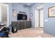 Home office featuring custom blue built-in cabinets, a desk, and shuttered windows for natural light at 22847 N 53Rd E St, Phoenix, AZ 85054