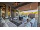 Covered patio with outdoor seating, ceiling fan, and view of the landscaped backyard at 22847 N 53Rd E St, Phoenix, AZ 85054