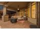 Covered patio with brick flooring, plush seating, and outdoor entertainment setup at 22847 N 53Rd E St, Phoenix, AZ 85054