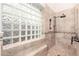 Modern walk-in shower with glass block window, sleek fixtures, and tiled walls, creating a spa-like experience at 22847 N 53Rd E St, Phoenix, AZ 85054
