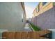 A practical side yard featuring a stone pathway and artificial turf at 22847 N 53Rd E St, Phoenix, AZ 85054