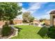 Expansive backyard featuring artificial turf, a built-in BBQ, and ample space for entertaining at 24226 N 22Nd St, Phoenix, AZ 85024