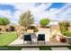 Landscaped backyard featuring a built-in barbecue area, seating and green lawn at 24226 N 22Nd St, Phoenix, AZ 85024