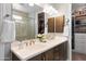 Bathroom featuring double sinks, modern fixtures, and a view into the walk-in closet at 24226 N 22Nd St, Phoenix, AZ 85024