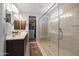 Bright bathroom with double vanity, glass shower, and walk-in closet at 24226 N 22Nd St, Phoenix, AZ 85024