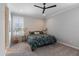 Bright bedroom with modern ceiling fan, a large window, and patterned bedding at 24226 N 22Nd St, Phoenix, AZ 85024