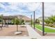 Bocce ball court with lighting and seating areas surrounded by mature trees at 24226 N 22Nd St, Phoenix, AZ 85024