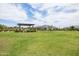 Expansive common area with grass, grill, covered seating, & mature landscaping at 24226 N 22Nd St, Phoenix, AZ 85024