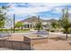 Community gathering space with fire pit, seating, mature trees and landscape at 24226 N 22Nd St, Phoenix, AZ 85024