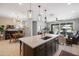 Open-concept kitchen with island seating flows into dining and living areas, offering a spacious feel at 24226 N 22Nd St, Phoenix, AZ 85024