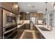 Well-equipped kitchen with stainless steel appliances, dark wood cabinetry, and an inviting center island at 24226 N 22Nd St, Phoenix, AZ 85024
