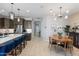 Open-concept kitchen and dining area with stylish lighting, a center island, and modern appliances at 24226 N 22Nd St, Phoenix, AZ 85024