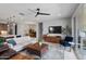 Bright living room with modern furnishings, ceiling fan, and sliding glass doors to the patio at 24226 N 22Nd St, Phoenix, AZ 85024