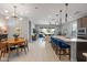 Open-concept kitchen and living area featuring sleek countertops, a modern chandelier, and ample natural light at 24226 N 22Nd St, Phoenix, AZ 85024