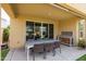Covered outdoor dining area with seating for eight, and wood storage at 24226 N 22Nd St, Phoenix, AZ 85024