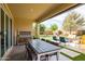 Covered outdoor dining area with BBQ, seating, and landscaped backyard at 24226 N 22Nd St, Phoenix, AZ 85024