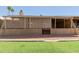 Back porch has screening for shade, gravel yard and grassy yard in view at 25230 S Berry Brook Dr, Sun Lakes, AZ 85248