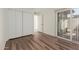 Bright bedroom featuring laminate floors, closet, and sliding door to backyard at 25230 S Berry Brook Dr, Sun Lakes, AZ 85248