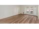 Open living room with wood-look floors and sliding glass doors to the patio at 25230 S Berry Brook Dr, Sun Lakes, AZ 85248