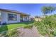 A well-maintained backyard featuring low-maintenance artificial turf and a covered patio at 25659 W Forest Grove Ave, Buckeye, AZ 85326