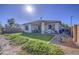 Spacious backyard with artificial turf, covered patio, and desert landscaping, perfect for outdoor enjoyment at 25659 W Forest Grove Ave, Buckeye, AZ 85326