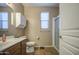 Well-lit bathroom features a shower, toilet, vanity, and wall cabinet for ample storage and convenience at 25659 W Forest Grove Ave, Buckeye, AZ 85326