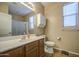 Bright bathroom showcases a large mirror, vanity with storage, and a shower for a refreshing experience at 25659 W Forest Grove Ave, Buckeye, AZ 85326
