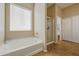 Bathroom features soaking tub, a shower, and large window with plenty of natural light at 25659 W Forest Grove Ave, Buckeye, AZ 85326