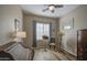 Well lit bedroom featuring a wood-look floor, neutral paint, and a collection of musical items at 25659 W Forest Grove Ave, Buckeye, AZ 85326