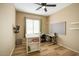 Bright bedroom featuring a ceiling fan, sewing machine, and work area at 25659 W Forest Grove Ave, Buckeye, AZ 85326
