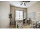 Versatile bedroom with a window, ceiling fan, and ample space, perfect for various activities at 25659 W Forest Grove Ave, Buckeye, AZ 85326