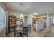 Dining area adjacent to open kitchen features wood-look floors and stylish chandelier at 25659 W Forest Grove Ave, Buckeye, AZ 85326