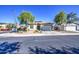 Inviting single-story home with desert landscaping, mature trees, and a well-maintained front yard at 25659 W Forest Grove Ave, Buckeye, AZ 85326