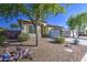Charming single-story home with desert landscaping, mature trees, and a well-maintained front lawn at 25659 W Forest Grove Ave, Buckeye, AZ 85326