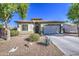 Inviting single-story home with low-maintenance landscaping, mature trees, and a welcoming facade at 25659 W Forest Grove Ave, Buckeye, AZ 85326