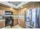 Charming kitchen featuring wood cabinetry, stainless steel appliances, and neutral countertops at 25659 W Forest Grove Ave, Buckeye, AZ 85326