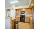Bright kitchen with wood cabinetry and modern black appliances at 25659 W Forest Grove Ave, Buckeye, AZ 85326