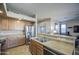 Open kitchen with stainless steel appliances, breakfast bar and view to living area at 25659 W Forest Grove Ave, Buckeye, AZ 85326
